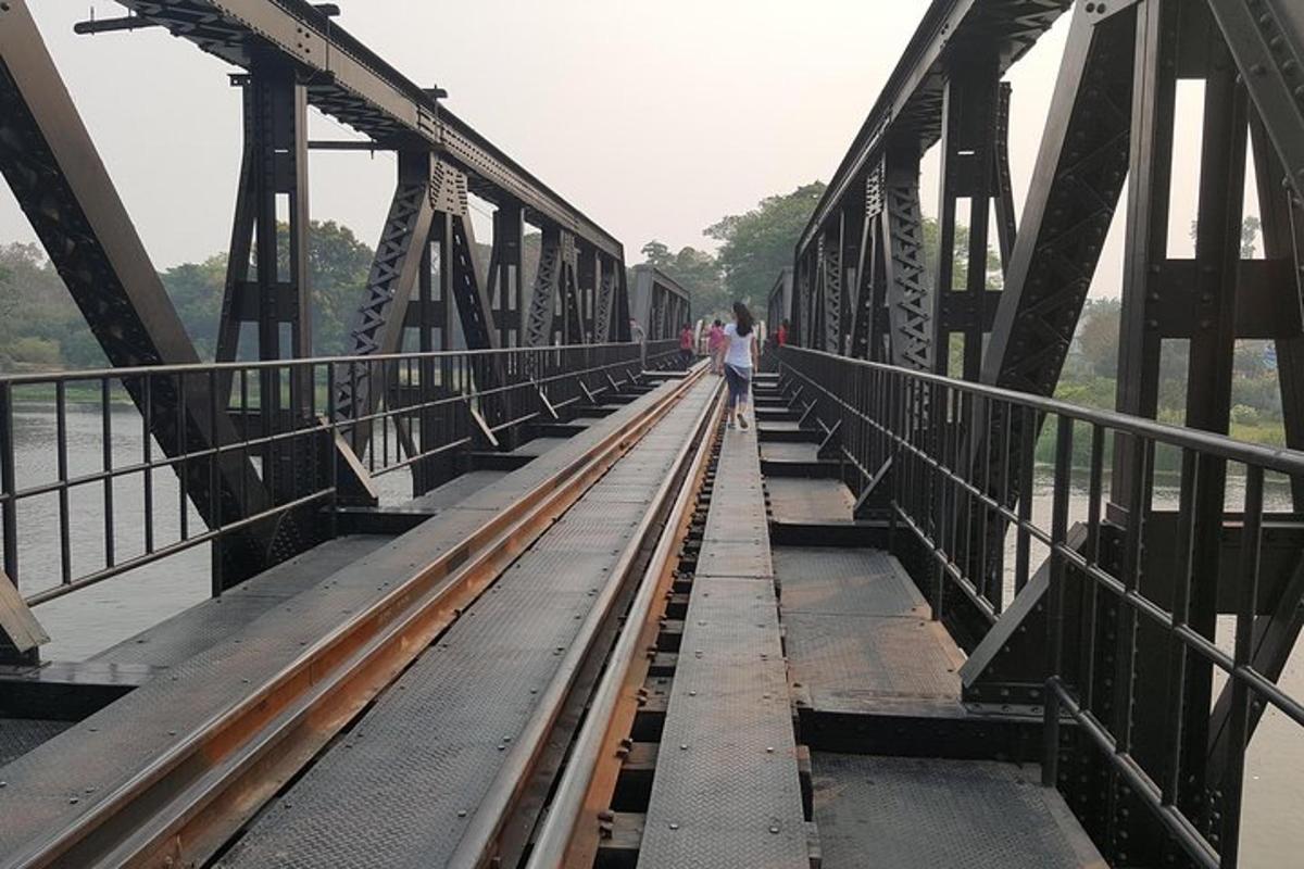 a bridge over a river with people walking on it