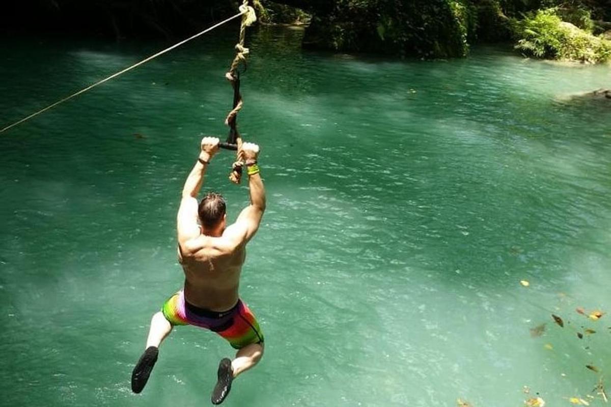 Un hombre colgado de una cuerda en el agua