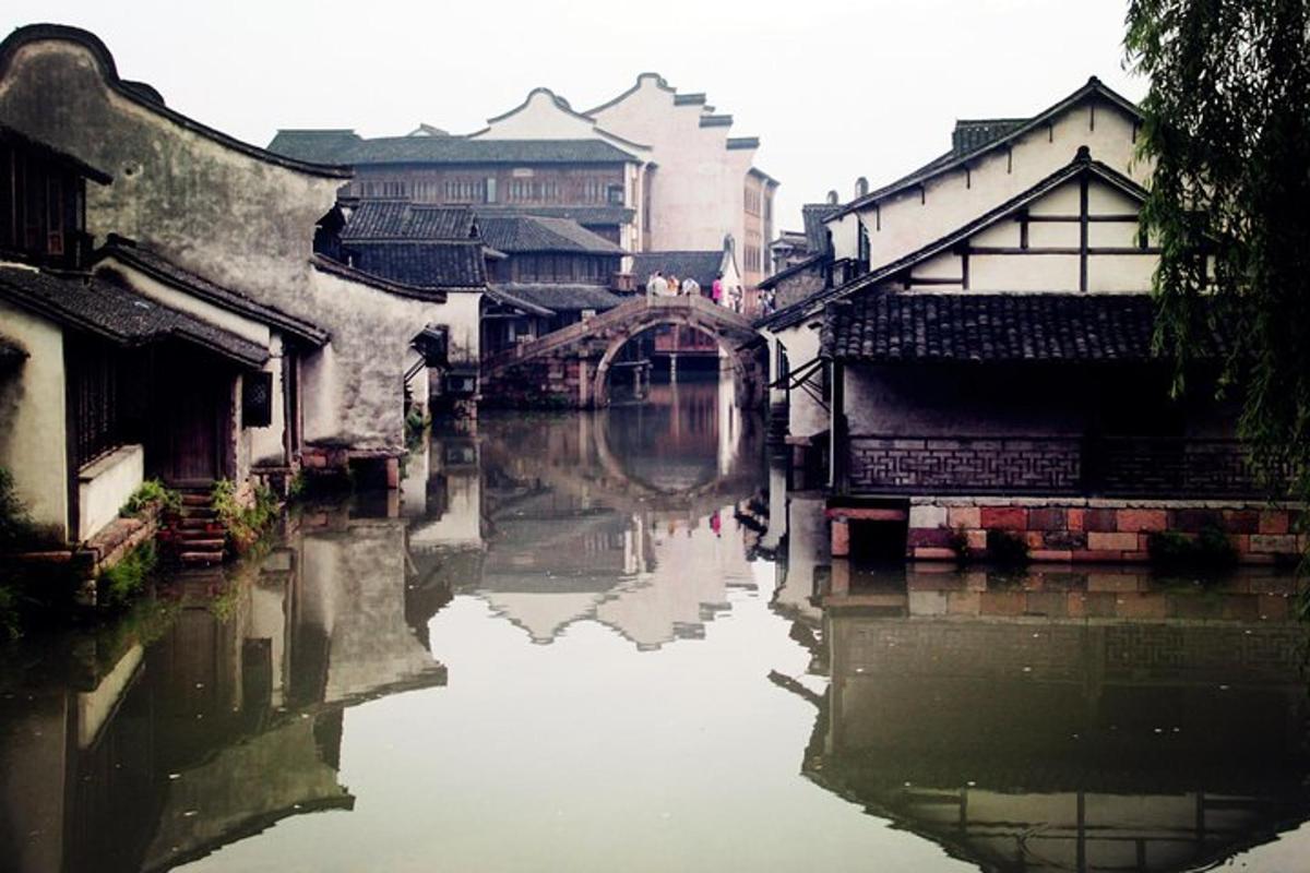 a river in a city with buildings and a bridge