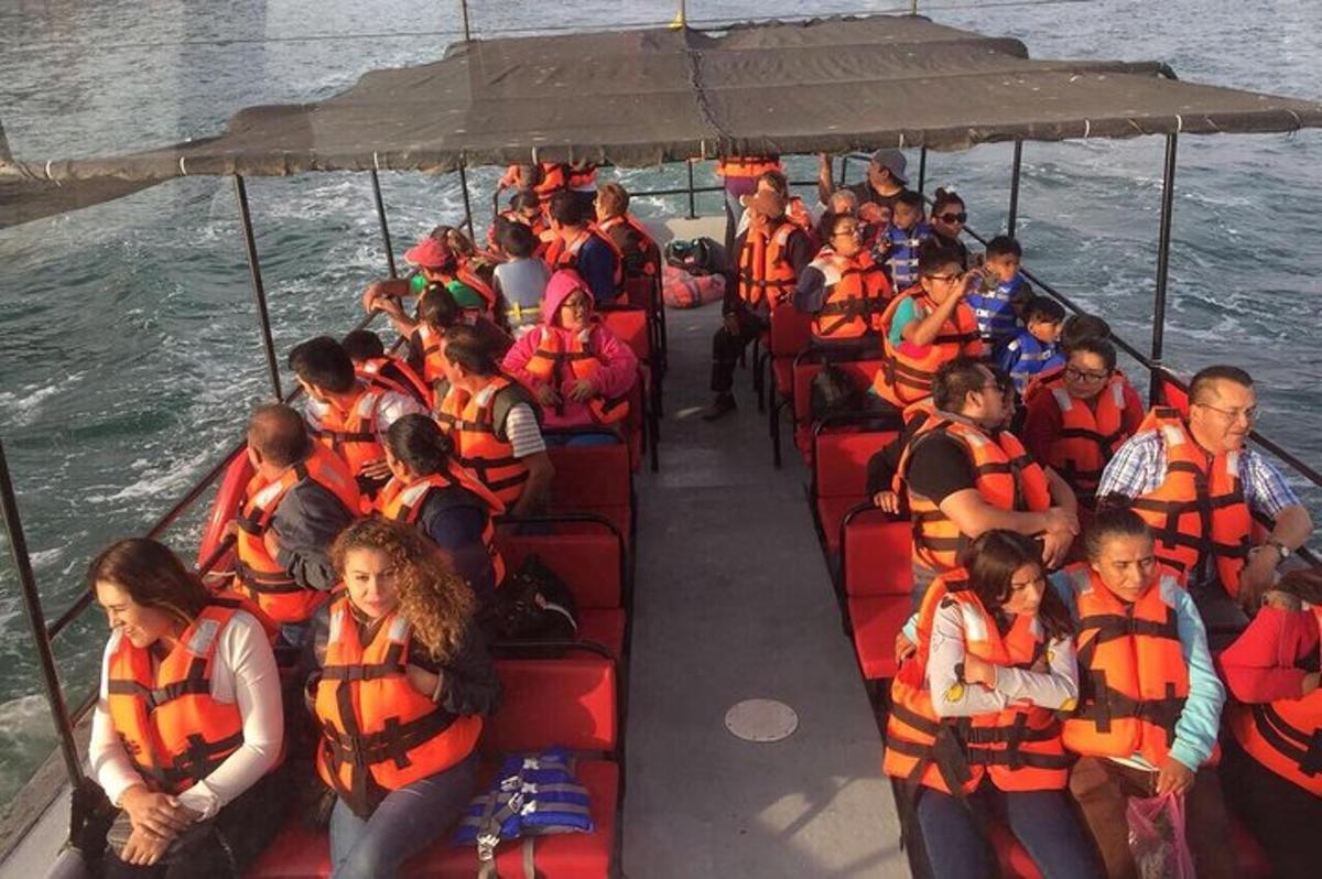 a group of people in life jackets on a boat