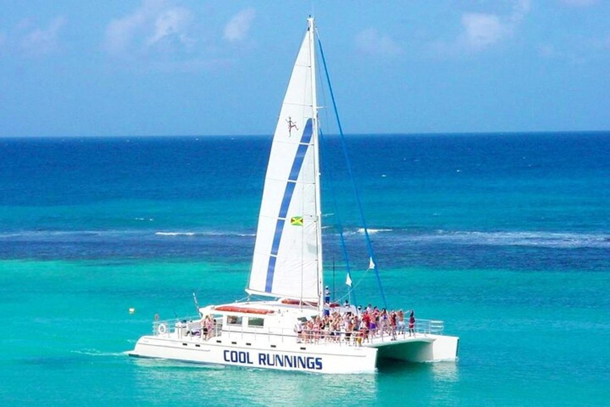 a group of people on a sail boat in the ocean