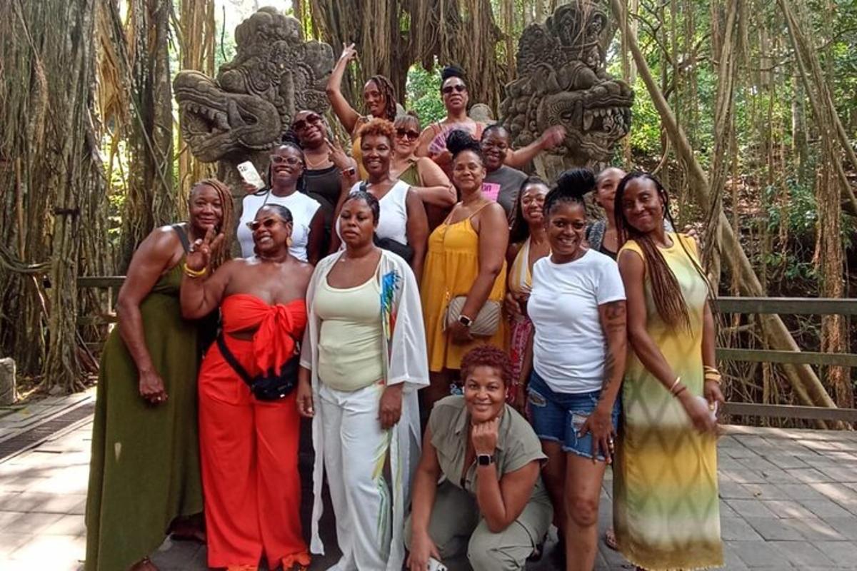 a group of people posing for a picture in front of some trees
