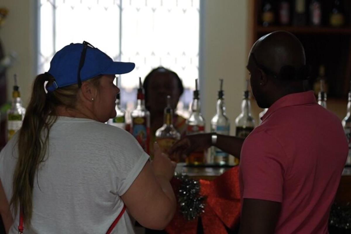 a woman standing at a bar talking to a bartender
