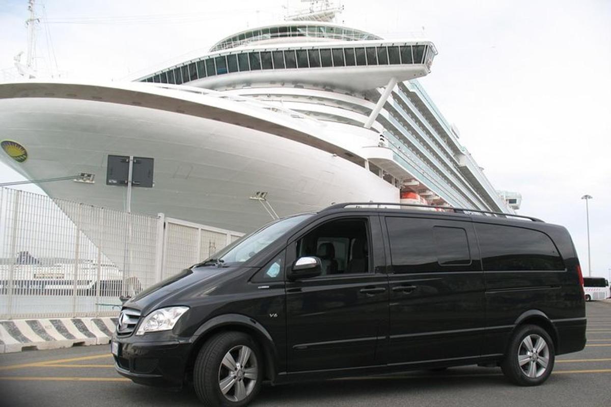 a black van parked in front of a cruise ship