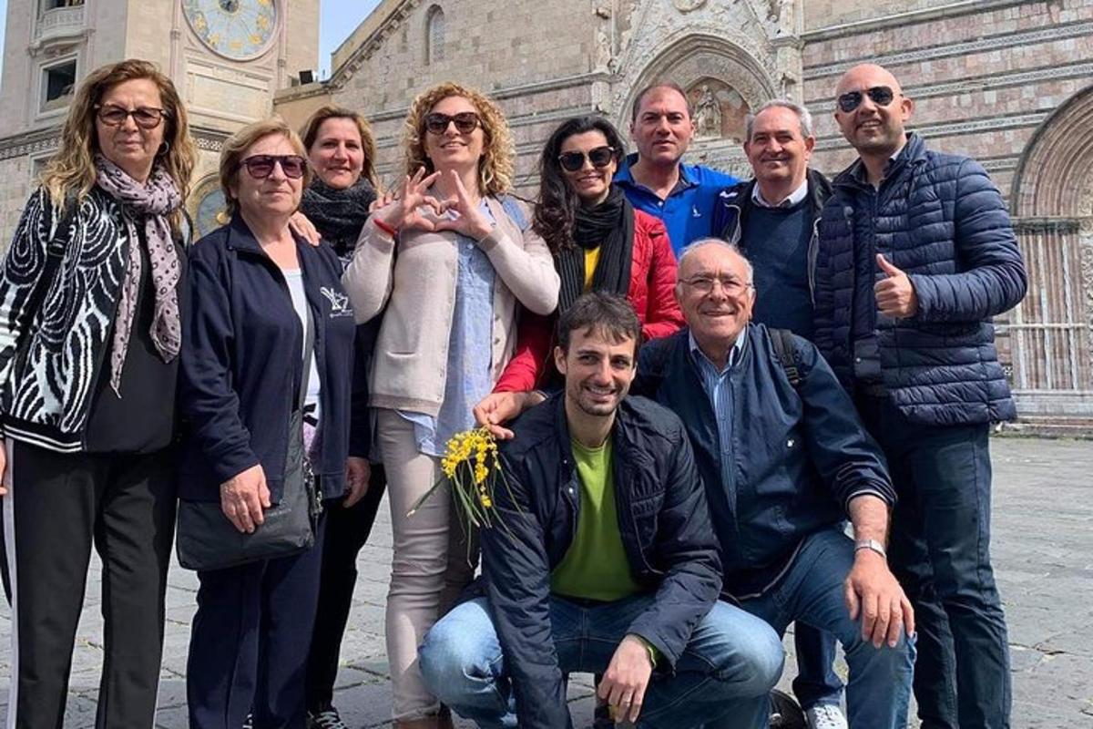 a group of people posing for a picture in front of a building