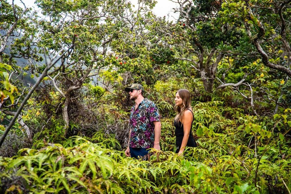 a man and a woman standing in the bushes