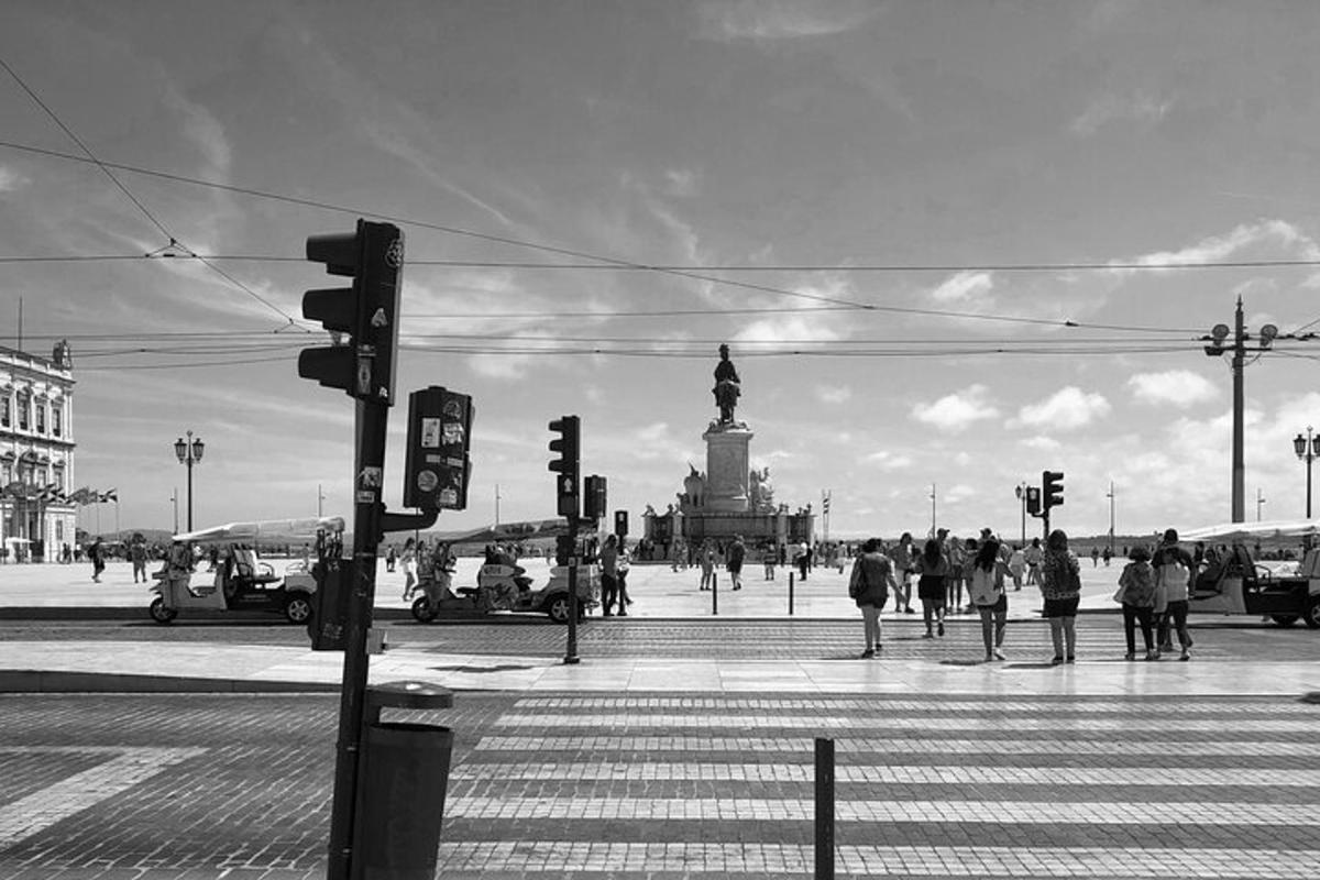a black and white photo of a city with a statue
