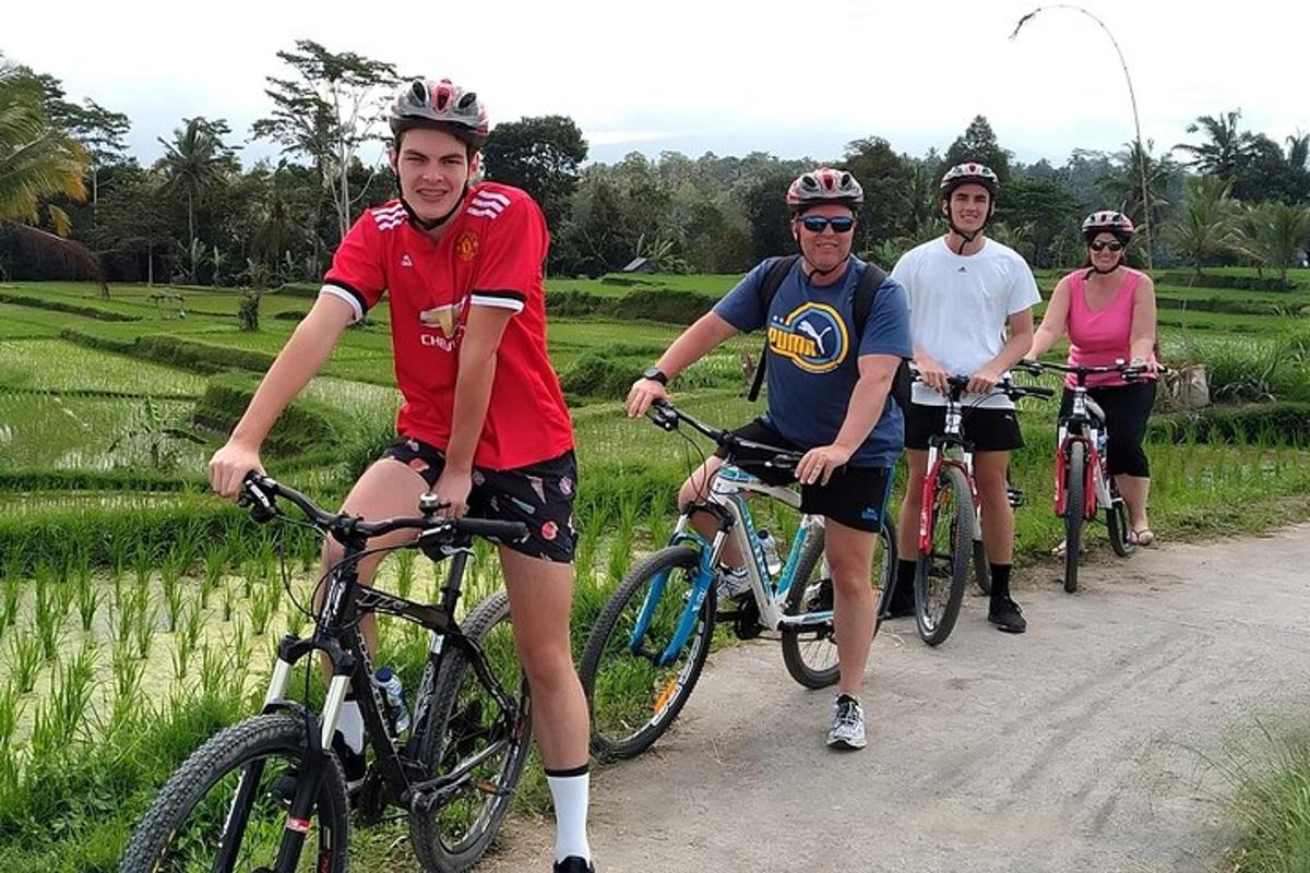 a group of people riding bikes down a dirt road