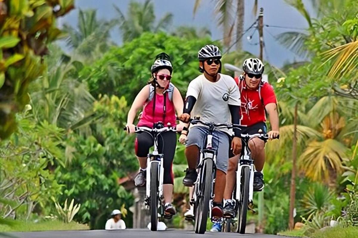 a group of people riding bikes down a road