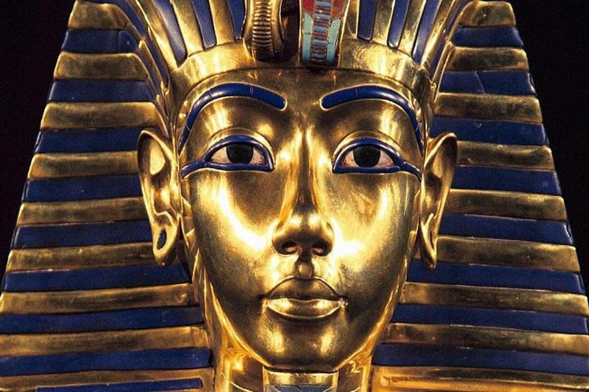 a gold mask of anubis is on display
