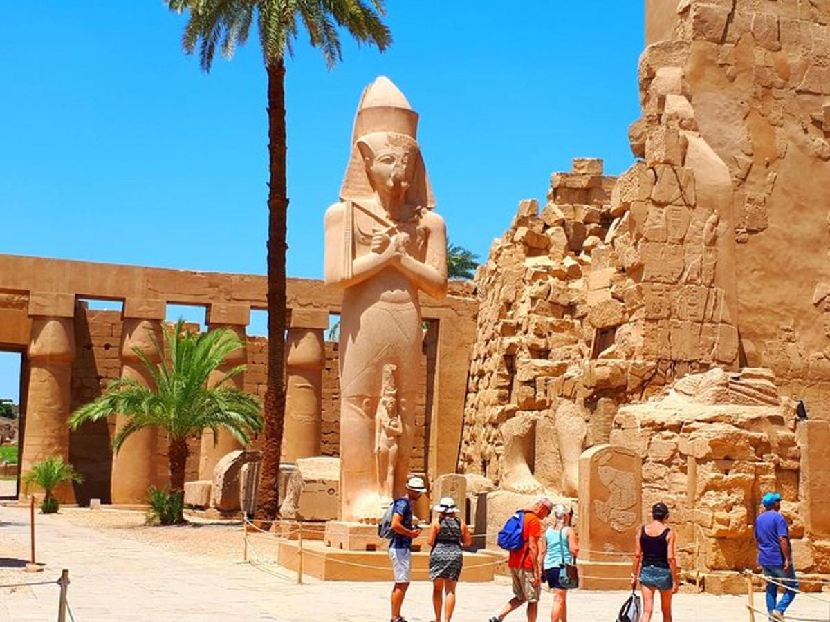 a group of people standing in front of a statue