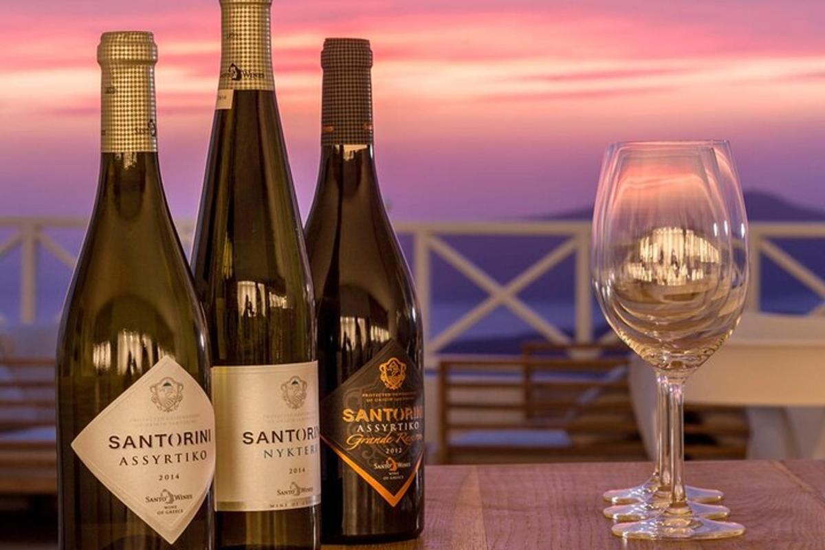 three bottles of wine sitting next to a wine glass