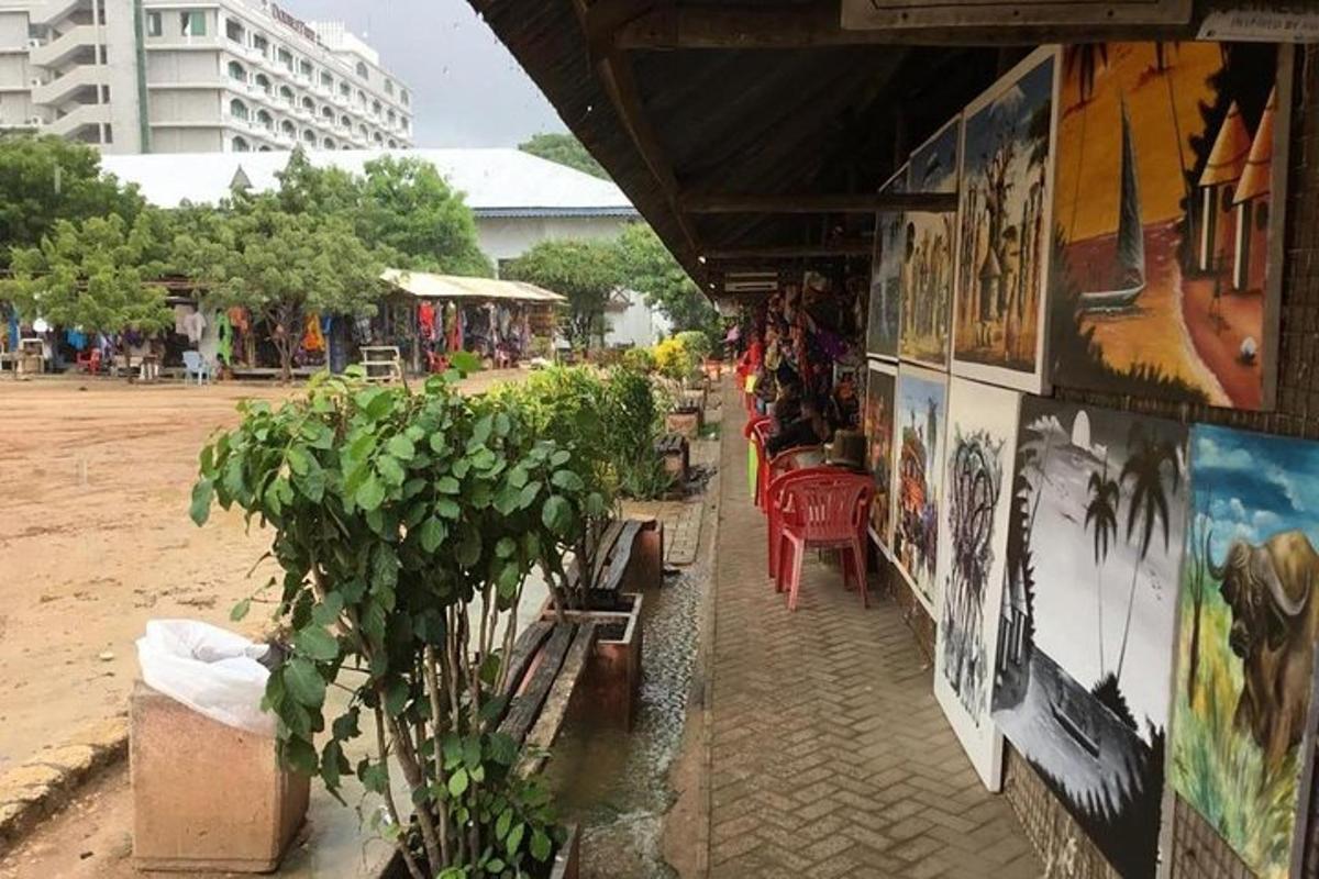 a market with paintings on the side of a building