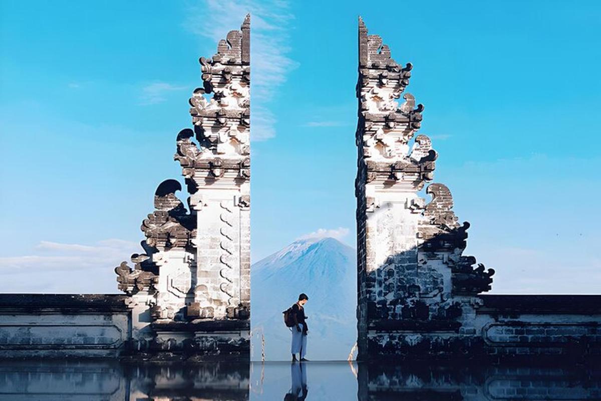a man standing in front of two tall towers