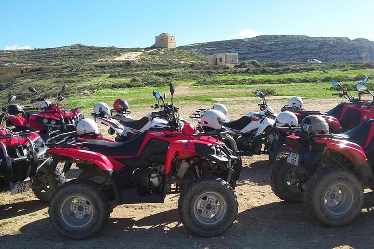 a group of motorcycles parked on a dirt road