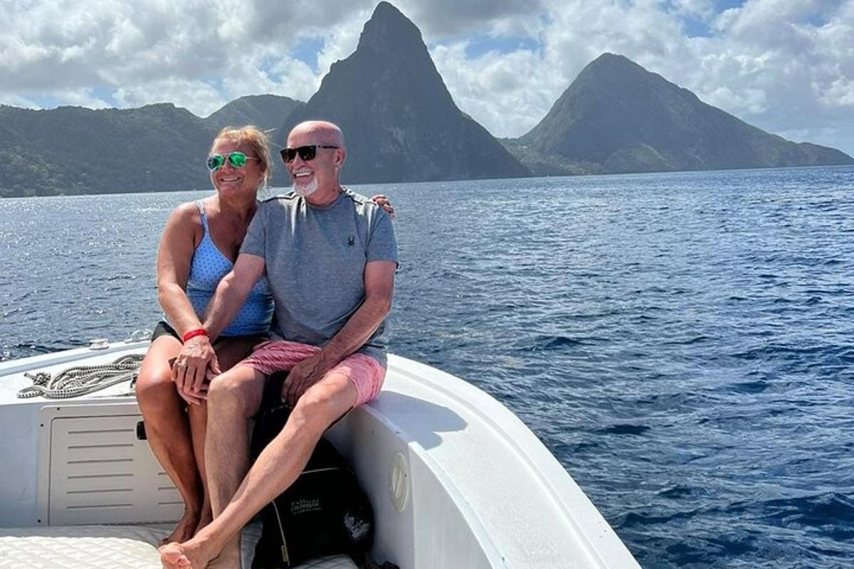 a man and woman sitting on the back of a boat