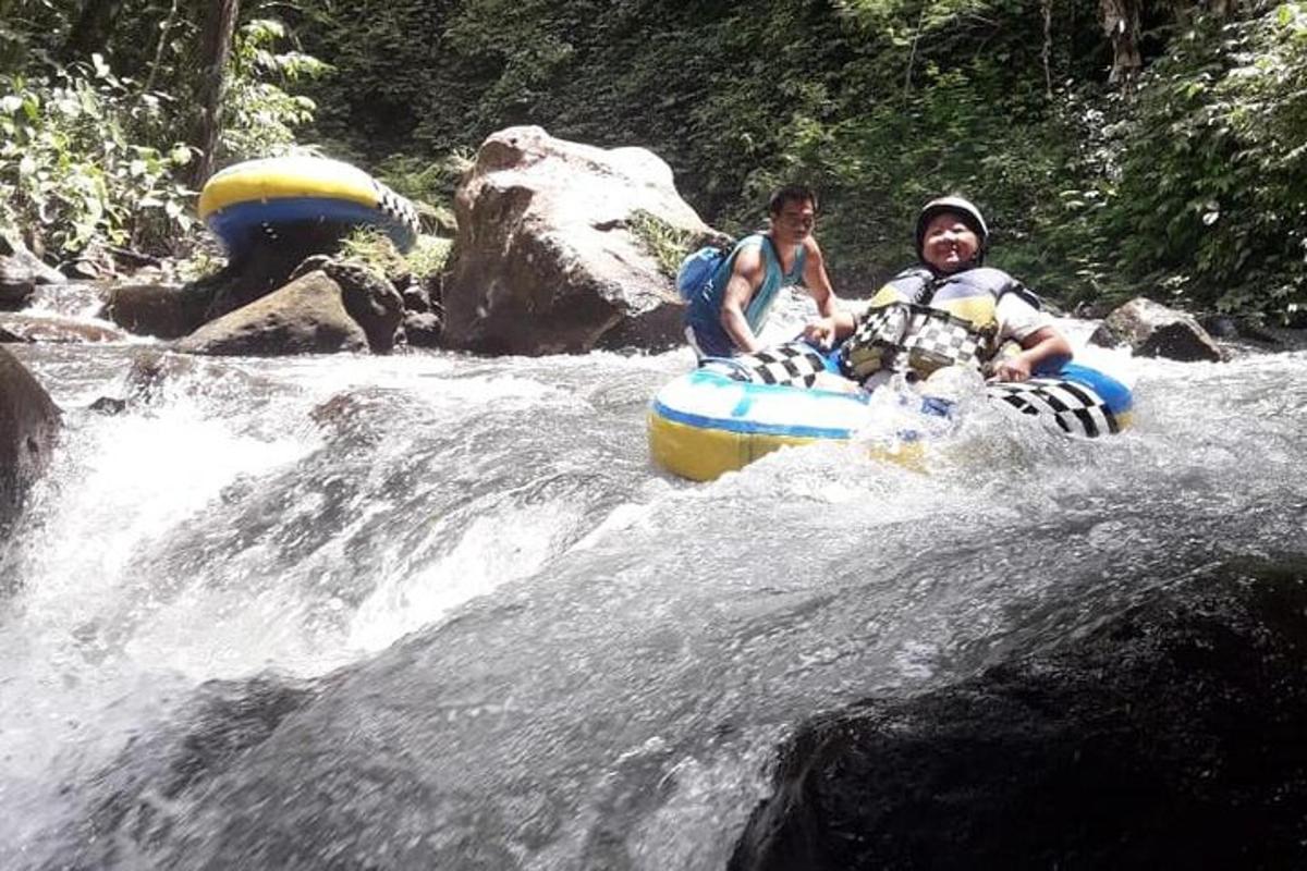 two people riding on a raft in a river