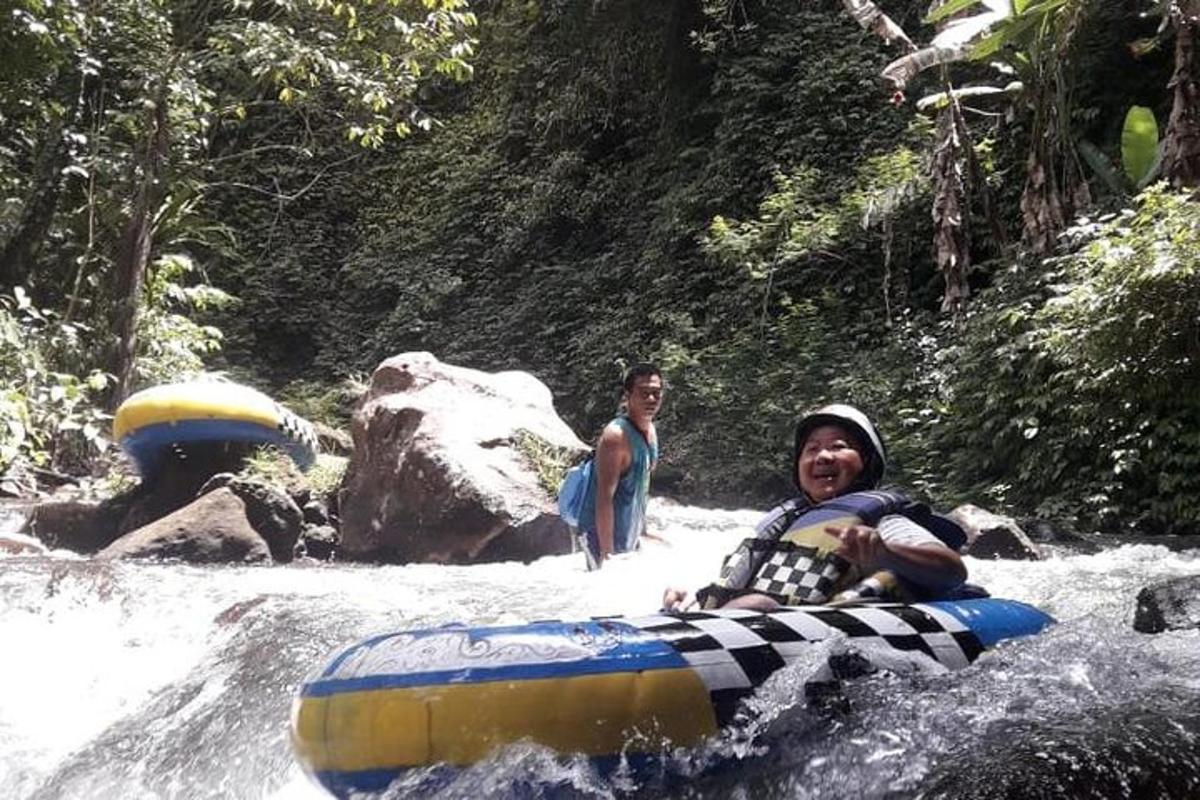 a man riding on a raft in a river