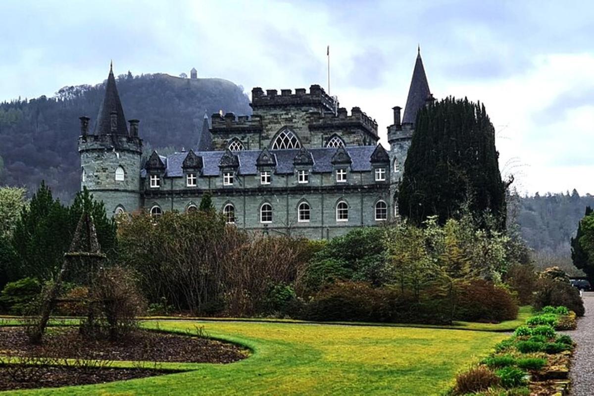 an old castle with a garden in front of it