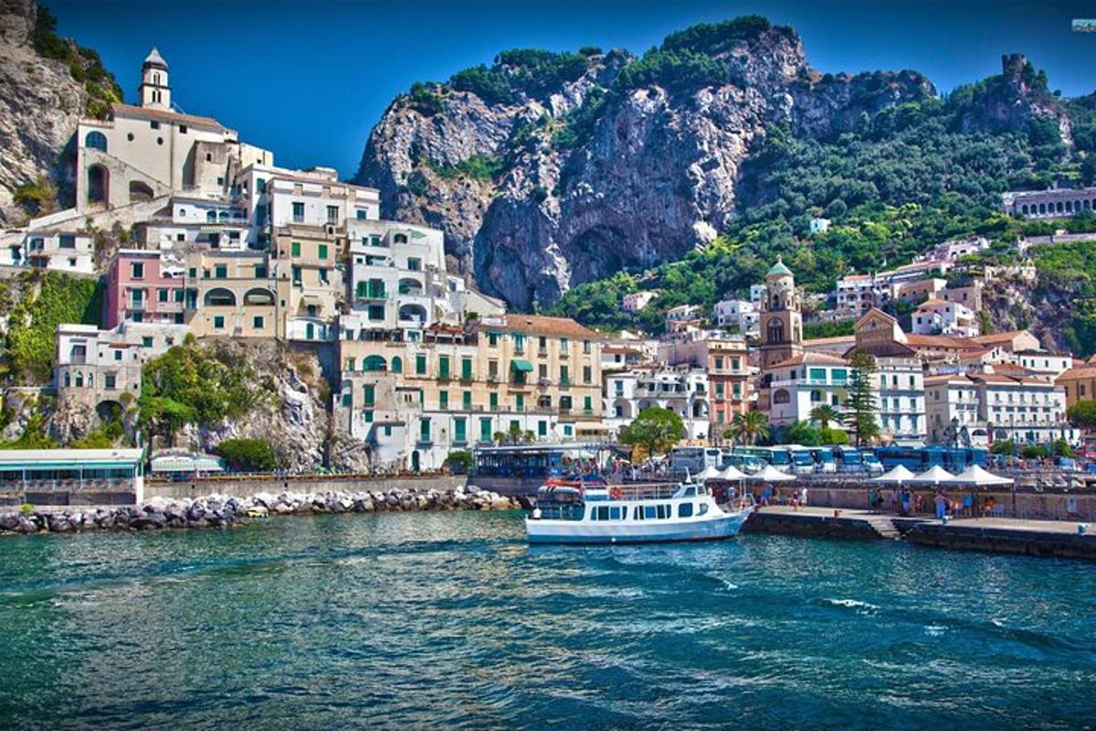 a boat in a body of water next to a city