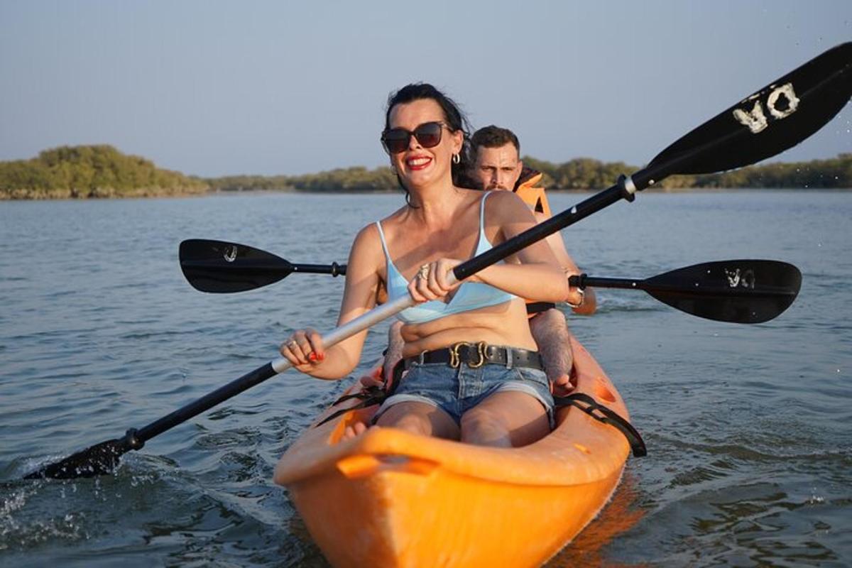 a man and a woman in a kayak on the water