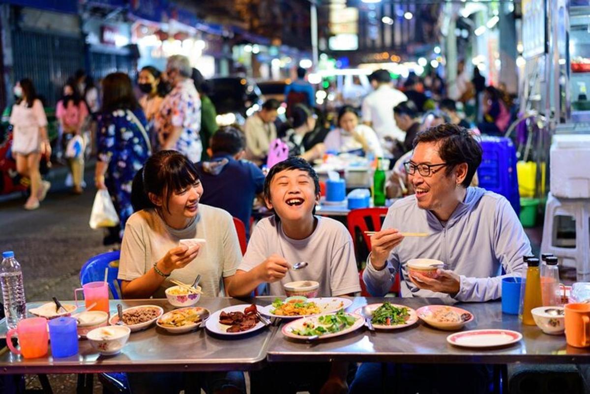 a group of people sitting at a table eating food