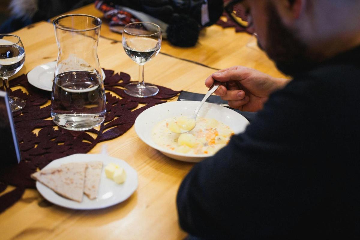 een man die aan een tafel zit met een bord eten