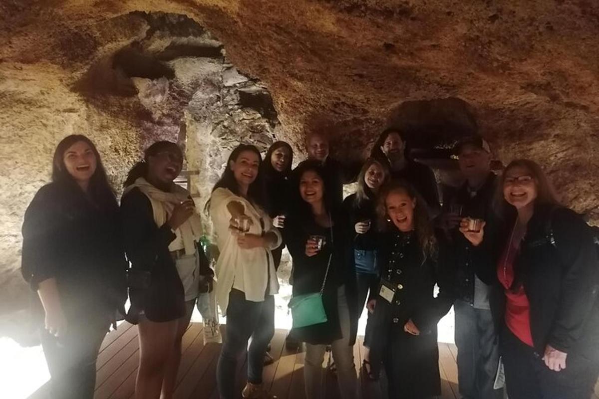 a group of people posing for a picture in a cave