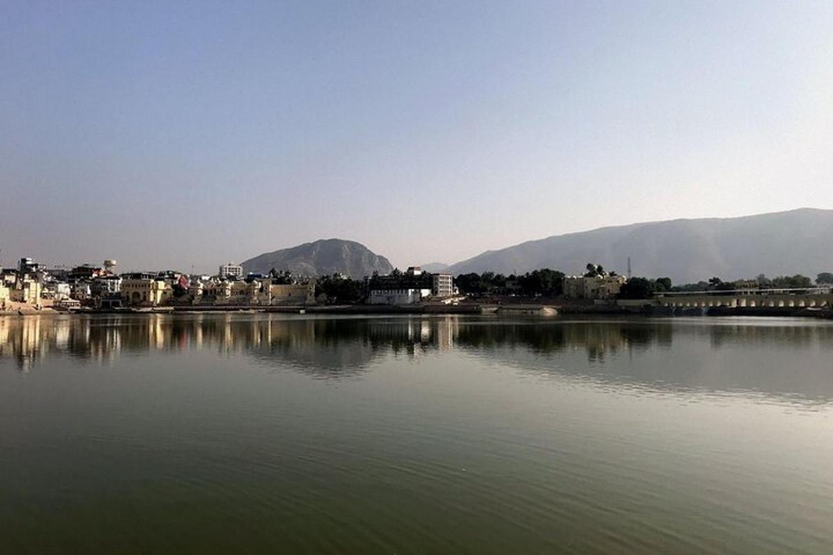 a large body of water with a city and mountains