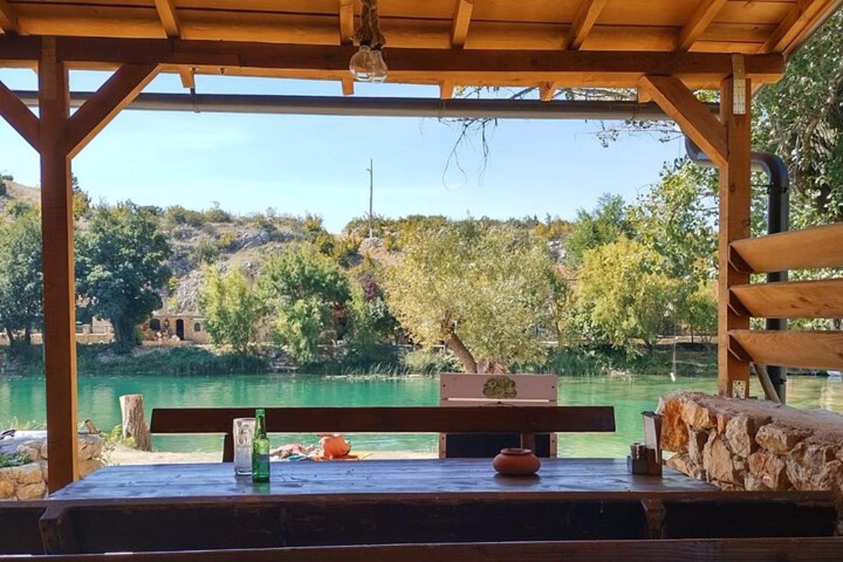 a table with a bench in front of a lake