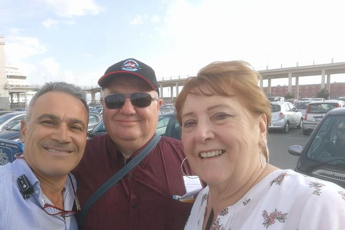 two men and a woman posing for a picture
