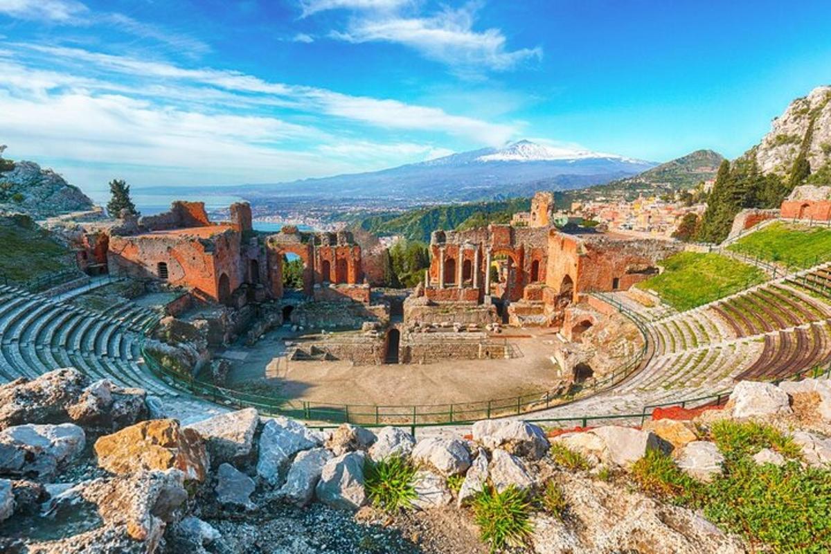 un antico anfiteatro con una montagna sullo sfondo