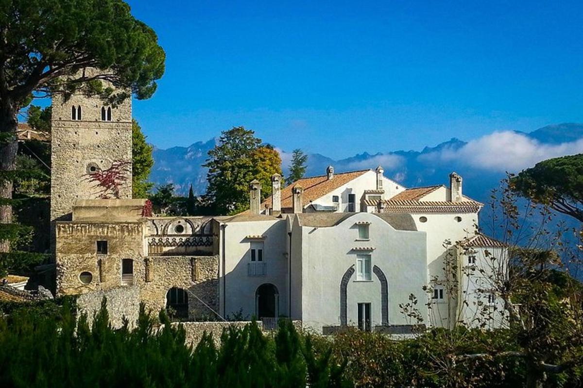 a large white building with a tower on a hill