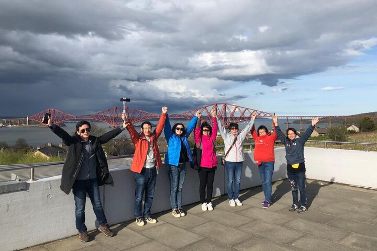 a group of people standing on a bridge with their hands in the air
