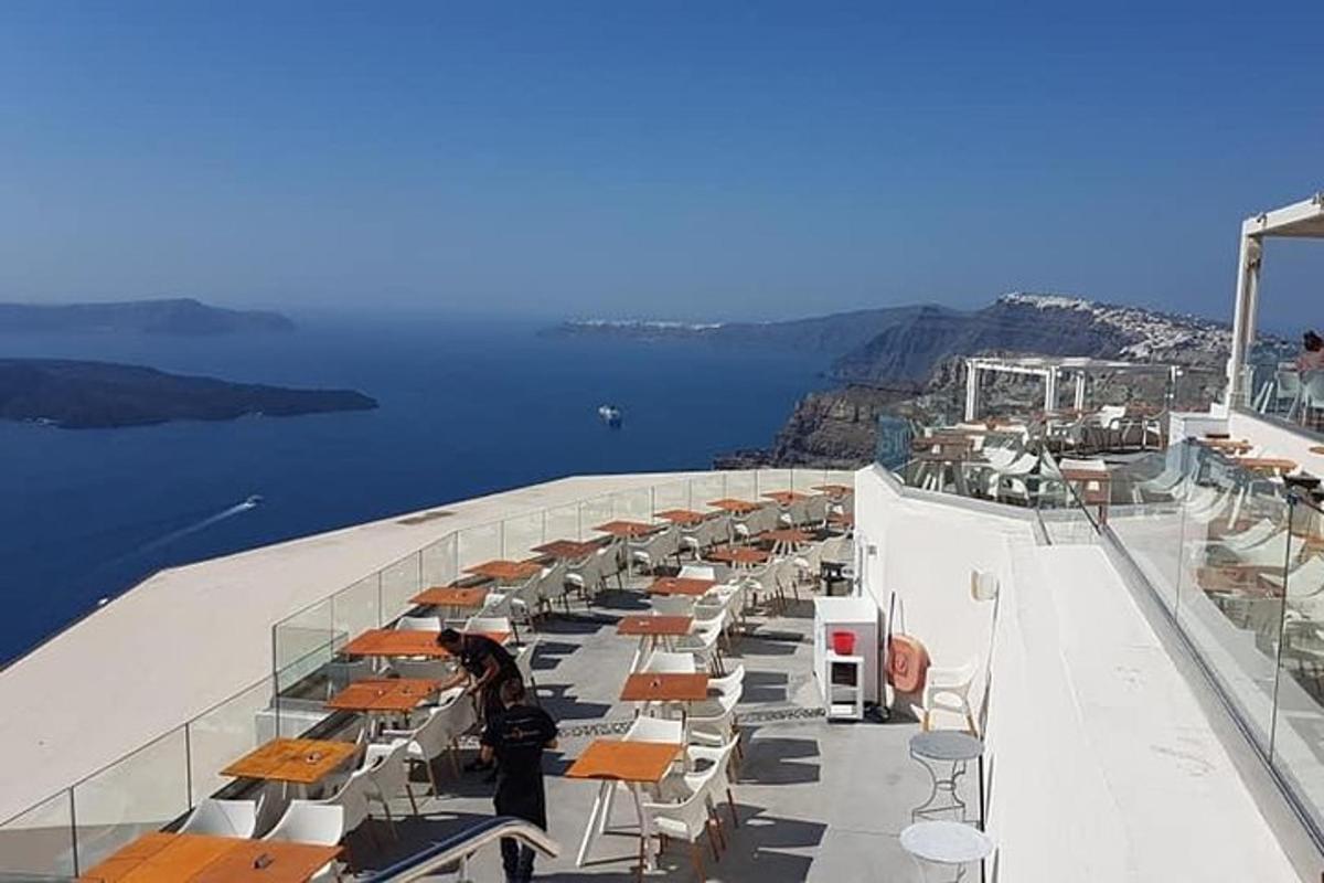 a balcony of a cruise ship with tables and chairs