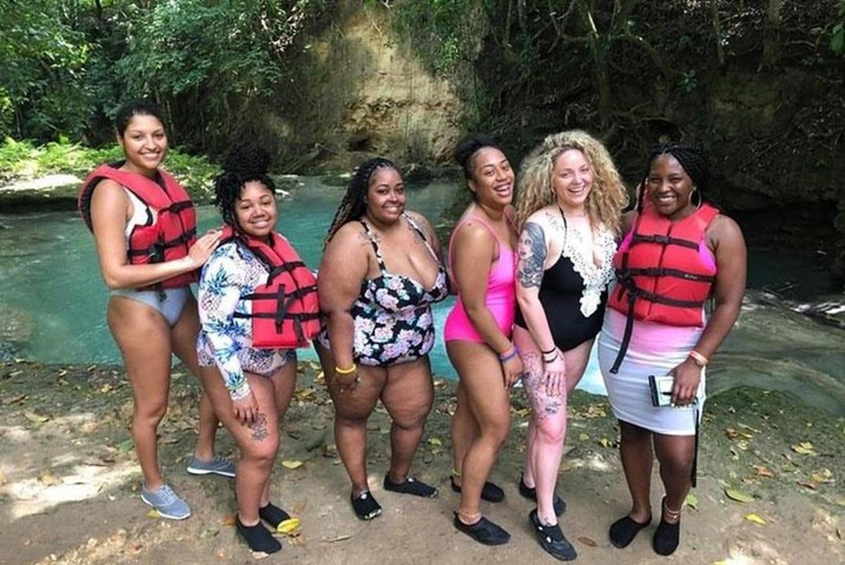 um grupo de mulheres em pé em frente a um rio