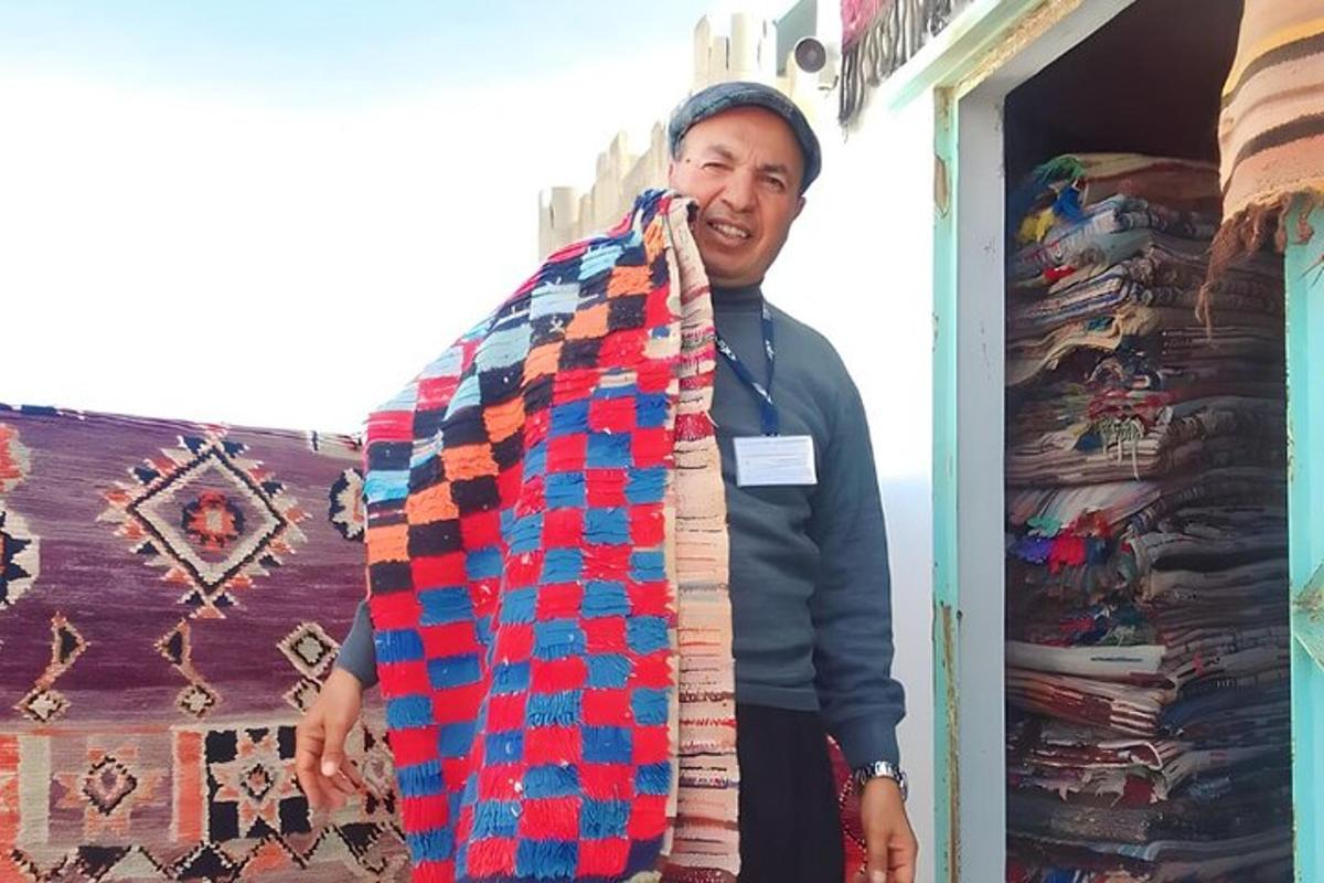 a man is holding up a neck tie