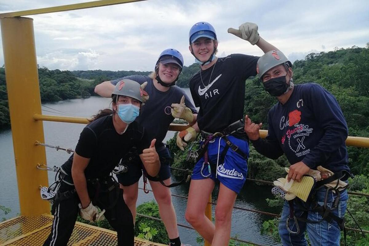 a group of people posing for a picture on a suspension bridge