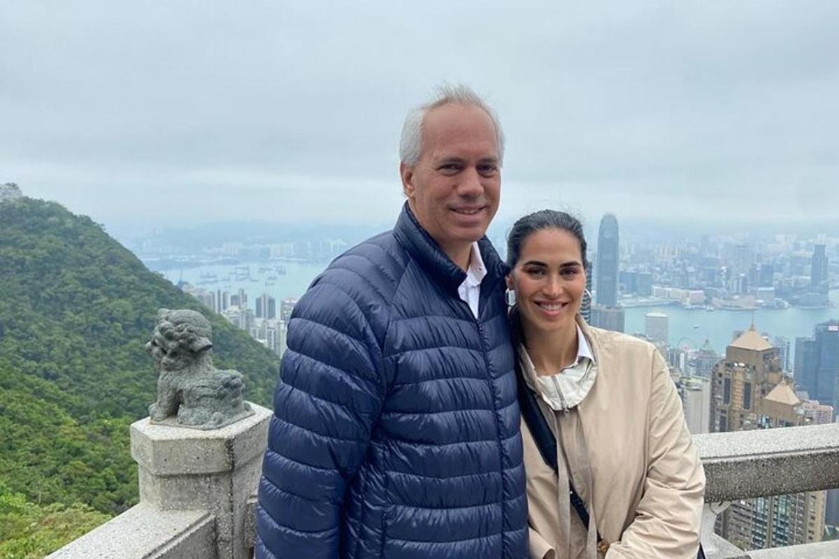 a man and a woman standing on top of a mountain