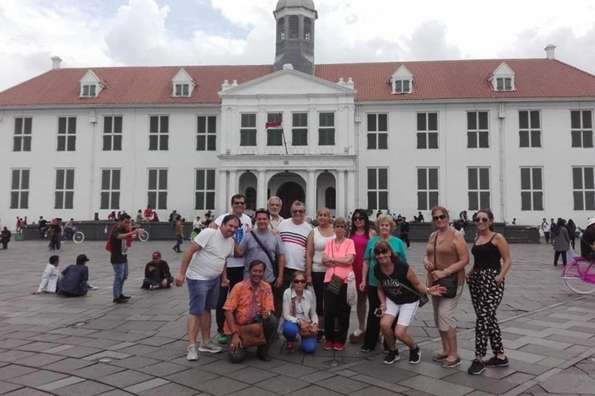 a group of people standing in front of a white building