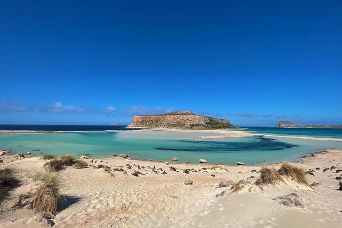 una platja amb una petita illa a l'aigua
