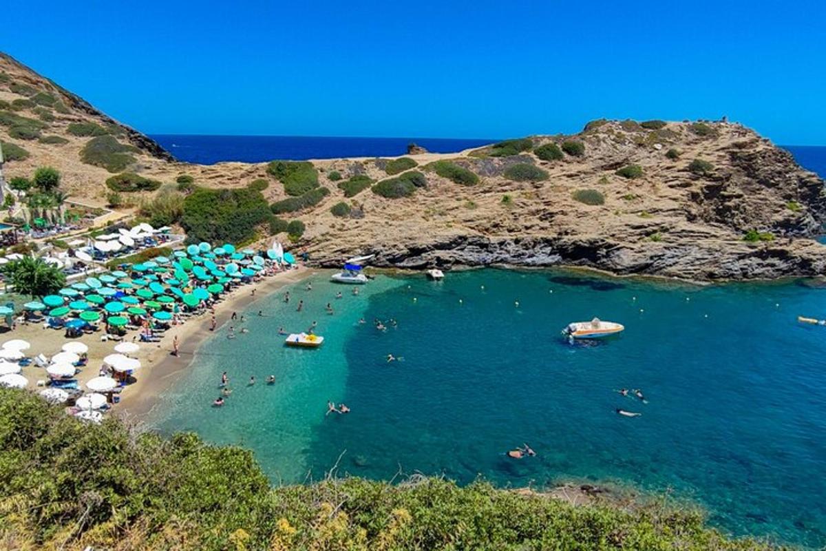 une plage avec des parasols et des gens dans l'eau