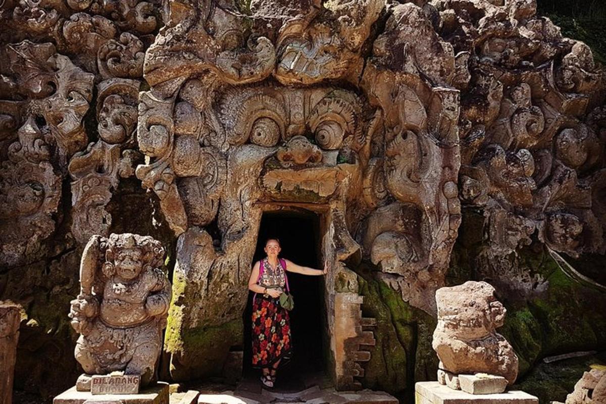 a woman standing in a doorway in a cave