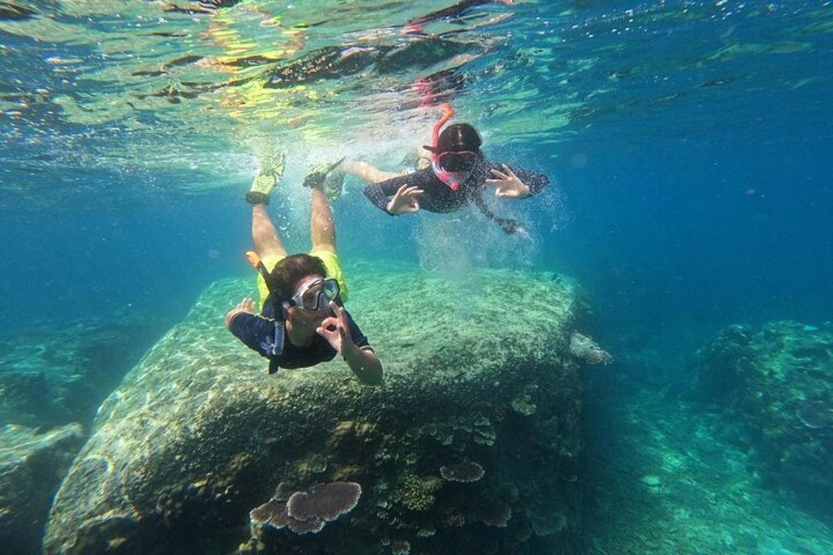 two people swimming in the water with a camera