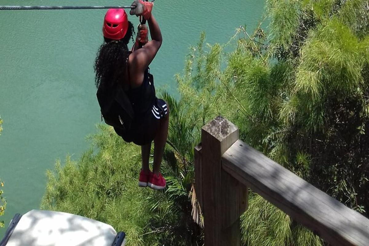 a man wearing a helmet standing next to a body of water