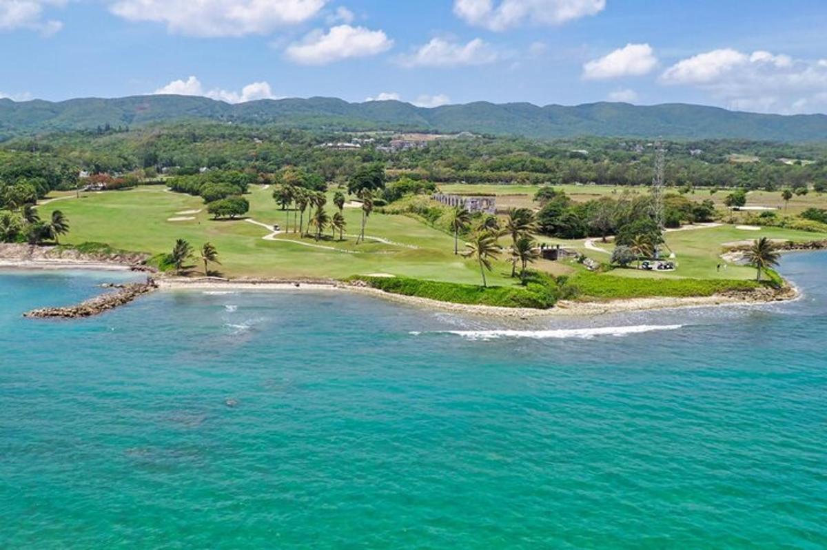 an aerial view of a golf course and the ocean