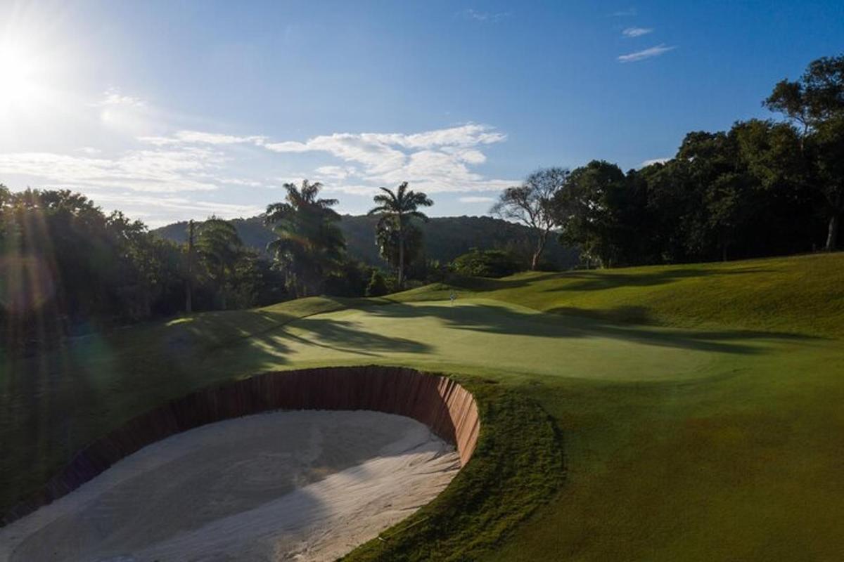 a golf course with a hole in the middle of a green