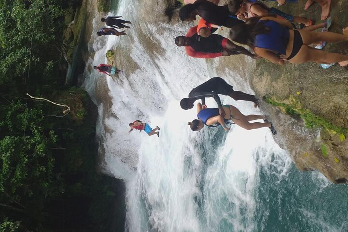 sekumpulan orang berdiri di atas air terjun