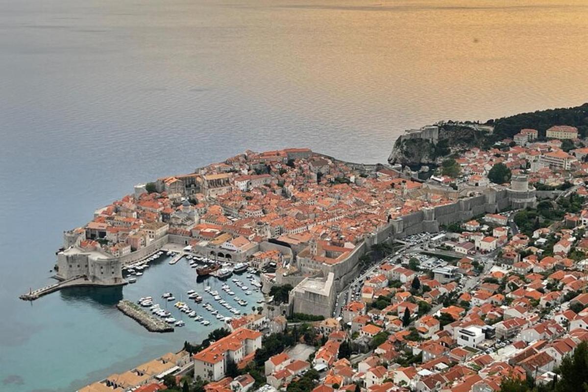 an aerial view of a city with boats in the water