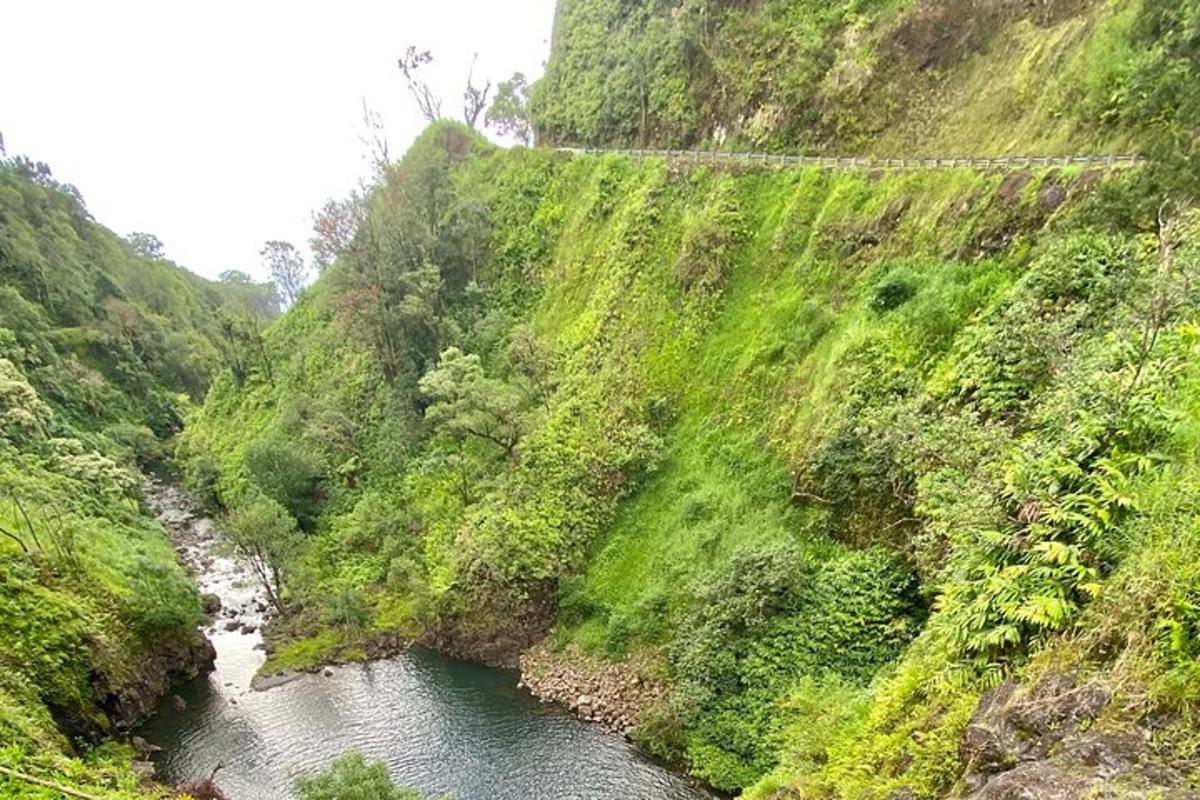 a mountain with a river and a bridge on it